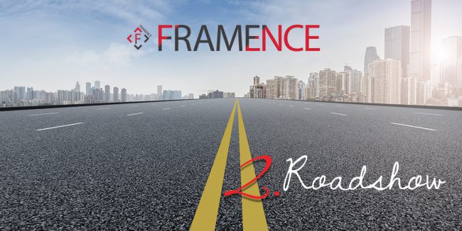 blog-roadshow2 Wide, asphalted road with yellow road markings leading into a modern city with many high-rise buildings. The FRAMENCE logo in black and red at the top center of the picture. At the bottom right is the handwritten inscription "2nd Roadshow