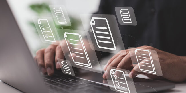 Framence_Blog_Audits "Person types on laptop keyboard; digital document icons float above the screen