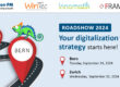 English version of the roadshow graphic with the same elements: road layout, markings for Bern and Zurich, logos and event data.